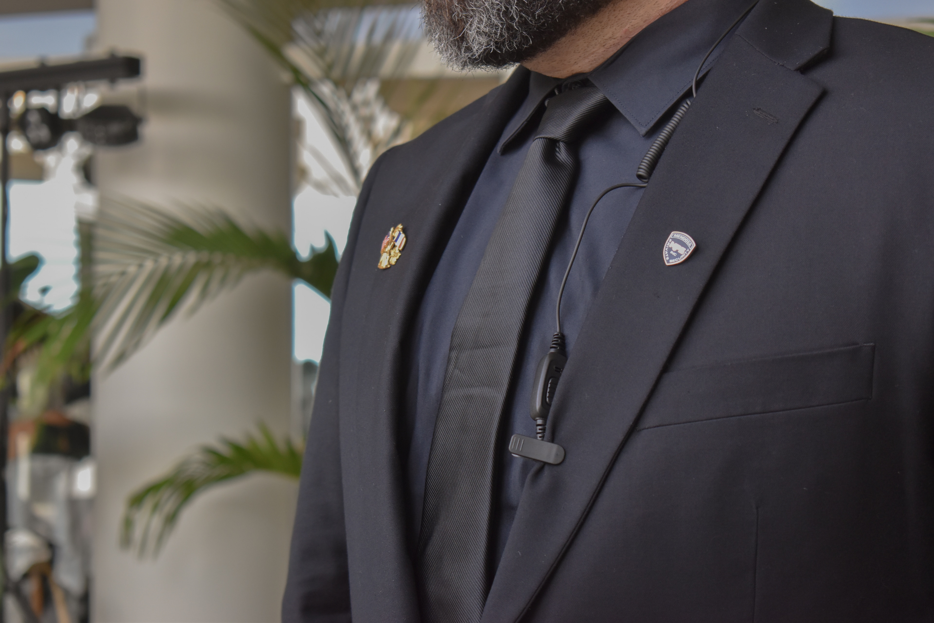 Close-up of an agent in a suit with an earpiece